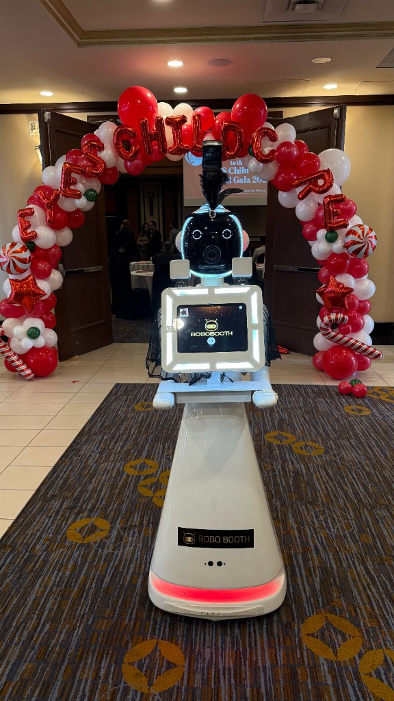 Robot Photobooth under a holiday balloon arch at a corporate gala